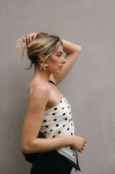a lady wears a silk scard as a top with a earring